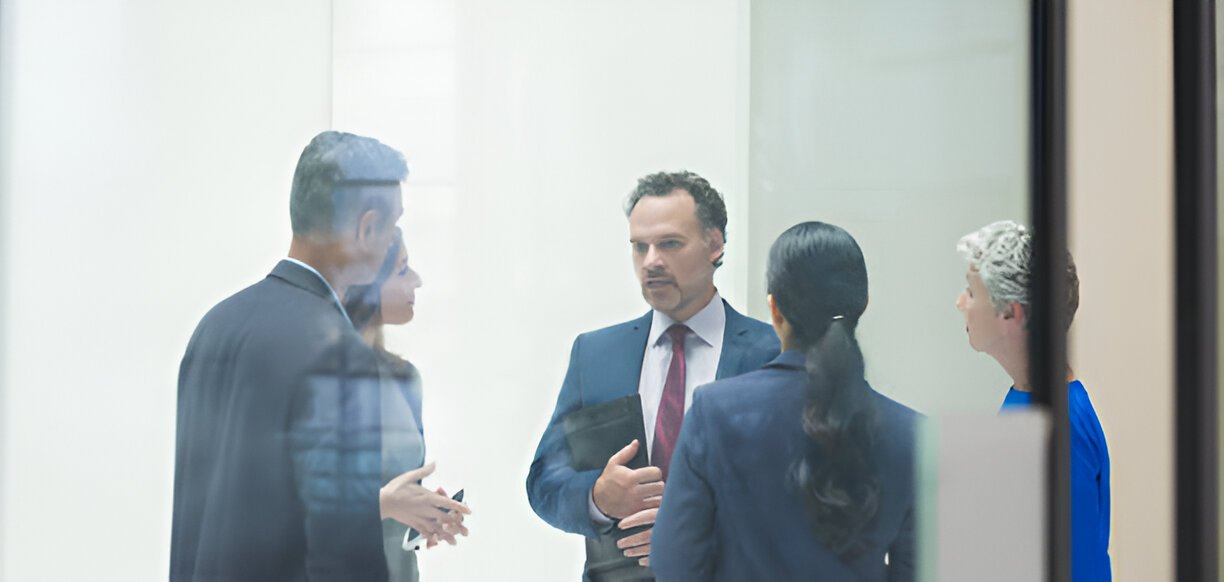 Professionals making a handshake agreement over documents